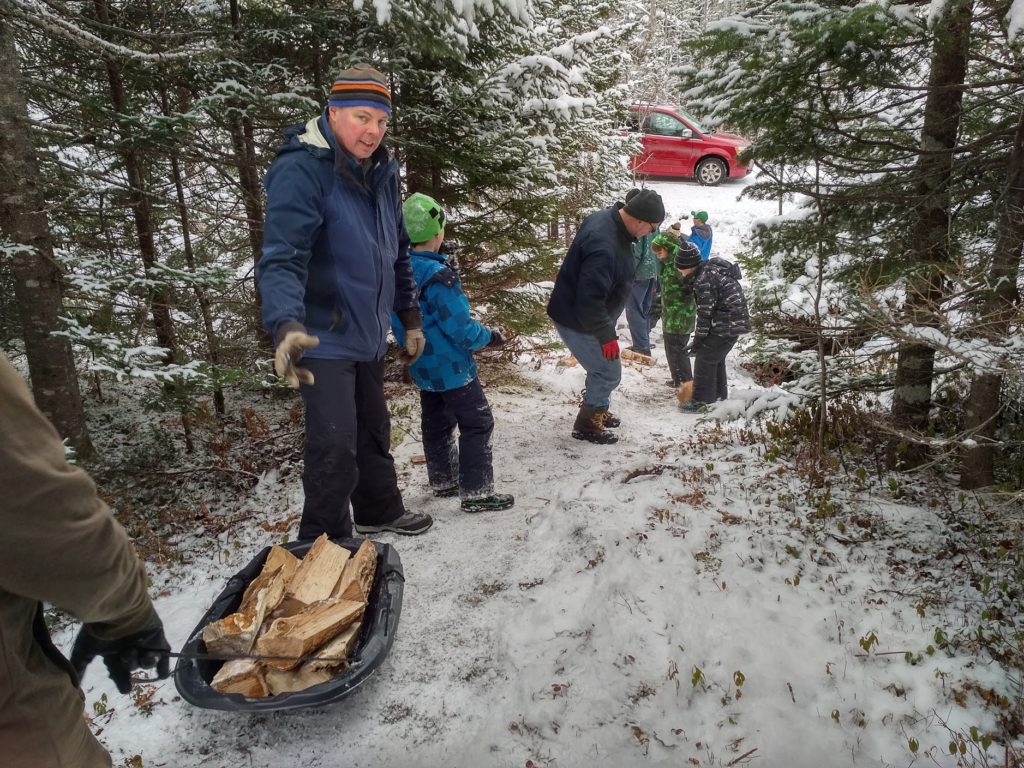 Moving wood to the cabin from the road.